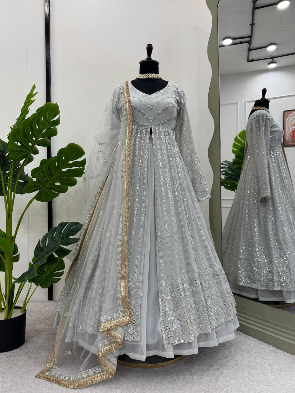 Elegant three-piece ensemble featuring a faux georgette top and lehenga with dupatta